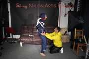 Sandra beeing tied and gagged by Stella in Shiny Nylon Rainwear crotchrope-suspended 