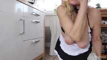 Busty blonde maid Cara cleans the kitchen