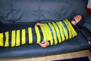Katharina taped and gagged in a blue nylon rainsuit