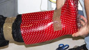 Simone tied and gagged in shiny nylon rainwear