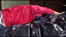 Sonja tied and gagged on bed with cuffs wearing a sexy rainwear combination (Video)