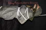Sexy Sandra being tied and gagged overhead with ropes and a clothgag hodded wearing a sexy rainwear combination (Pics)