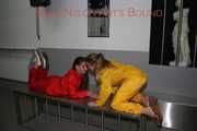 Watching Stella being tied and gagged with ropes and a ballgag on a operating table from Leonie both wearing sexy shiny nylon rainwear (Pics)