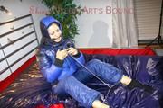 Lulu ties, gagges and hoodes herself on a bed with cuffs wearing a sexy black/blue shiny nylon down jacket and a darkblue rain pants (Pics)