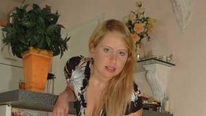 Benita opens her blouse and lifting her skirt in front of the kitchen