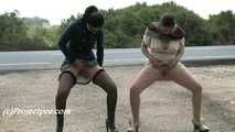 030051 Salma & Lucia Pee Together By The Side Of A Busy Road