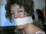 25 YR OLD CHARLENE IS WRAP GAGGED & CHAIR TIED TO A CHAIR WITH WHITE CLOTH MEDICAL TAPE (D47-14)