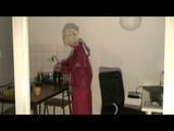 Blonde-haired archive girl being at home wearing shiny nylon rainwear (Video)
