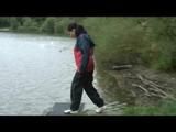 Sexy archive girl dressed with an shiny nylon adidas shorts and puts a rain pants and a rain jacket over it (Video)