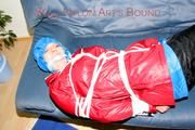 Jill tied, gagged and hooded on the sofa wearing a sexy black shiny nylon pants and two rain jackets (Pics)