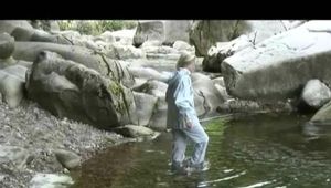 Sophie enjoying the water and weather on a river wearing supersexy grey rainwear (Video)