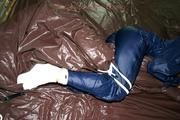 Stella tied and gagged in shiny nylon rainwear