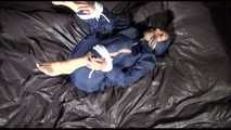 Sexy Sandra wearing a sexy blue shiny nylon pants and a sexy blue rain jacket tied and gagged with ropes and a cloth gag on a bed (Video)