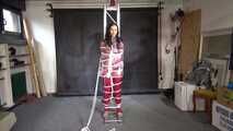 Aiyana in a shiny nylon red rainsuit and a see through PVC Rainjacket, tied gagged, hooded and vibed