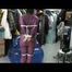 Video with Jill tied and gagged in a shiny purple semi transparent PVC suit