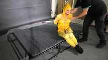 Ms Ungeniert tied and gagged in shiny nylon Rainwear trying to escape