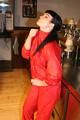 Jill posing in a bar wearing a sexy red rainwear combination with nothing under it (Pics)