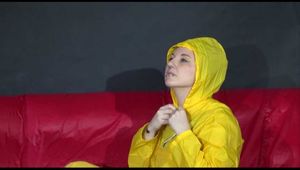 ***MARA*** ties and gagges with cuffs on the sofa wearing a supersexy oldschool yellow rain suit with hood (Video)