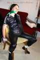 Lucy tied and gagged with rope and gag on a chair wearing a sexy black shiny nylon jumpsuit (Pics) 