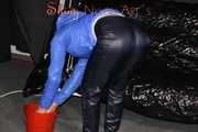 Sexy Sandra wearing a supersexy black shiny nylon rain pants and a sexy shiny blue rain jacket lolling on the sofa (Pics)