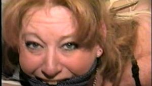 41 Yr OLD RED HEADED FAMOUS FASHION MODEL IS MOUTH STUFFED, CLEAVE GAGGED, HOG-TIED & TOE-TIED WEARING NYLON STOCKINGS PT 6 (D57-11)