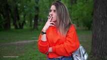 Pretty Kate is smoking Marlboro Red 100s in the park