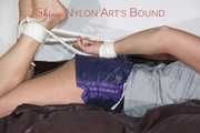 Watching Pia being tied and gagged on a sofa wearing a sexy shiny nylon shorts and a tshirt (Pics)
