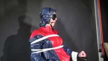 Watzching sexy PIA wearing a sexy oldschool rainwear combination in red/blue sitting on a hairdresser´s chair being tied and gagged from Sophie (Video)