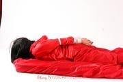 Jessy tied in a shiny nylon rainsuit