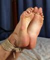 Tapegagged barefoot topless Kim, hogtied with hemp rope, is tickled by the man