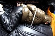 Jill tied and gagged in a shiny nylon down coat