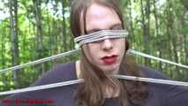 Mitzi tied up between 2 trees