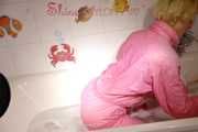 Sonja wearing a sexy pink down suit playing with the foam in her bath tub and enjoying the feeling in the wet clothes (Pics)