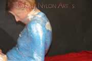 Watching sexy Pia being envelopped in film wearing a sexy blue shiny nylon shorts and a lightblue shiny nylon rainjacket (Pics)