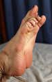 Tapegagged barefoot topless Kim, hogtied with hemp rope, is tickled by the man