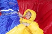 Sonja tied, gagged and hooded on a sofa wearing a sexy blue rain pants and a yellow downwear jacket (Pics)