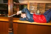 An archive girl tied and gagged on a bar wearing shiny nylon rainwear (Pics)