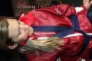 Sexy Sandra wearing sexy red/blue rainwear being tied and gagged with ropes and a clothgag on a chair (Pics)