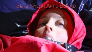 Sonja tied, gagged and hooded on bed with cuffs, chains and a gag wearing a sexy blue shiny nylon rain pants and a red rain jacket (Pics)