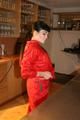 Jill posing in a bar wearing a sexy red rainwear combination with nothing under it (Pics)