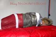 ***NEW MODEL*** Sandra wearing highheels and a sexy red crazy sensation skibib as well as a grey down jacket tied and gagged on a sofa with tape (Pics)