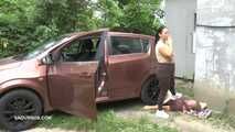 Mistress Jenna stands on the slave with a car while smoking in the slave's mouth B