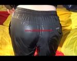 Lucy lolling in bed wearing a sexy black rainwear combination (Video)