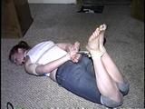 24 Yr OLD CRAFTER IS RING-GAGGED, BAREFOOT, HOG-TIED, WEARING JEANS, TOE-TIED, HANDGAGGED & DROOLS (D64-6)