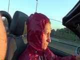 Watch Sandra taking a Walk during very hot Weather enjoying her rubberized oldschool Rainsuit
