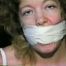25 YR OLD CHARLENE IS WRAP GAGGED & CHAIR TIED TO A CHAIR WITH WHITE CLOTH MEDICAL TAPE (D47-14)