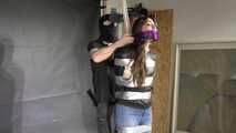 Poor Marie bound and gagged in a shiny nylon Windbreaker