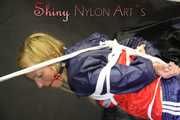 SANDRA being tied and gagged overhead with ropes and a clothgag wearing a sexy oldschool shiny nylon shorts and a rainjacket (Pics)