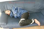 Katharina tied, gagged and hooded (breath control) on a sofa wearing sexy shiny nylon rainwear (Pics)