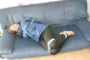 Katharina tied, gagged and hooded (breath control) on a sofa wearing sexy shiny nylon rainwear (Pics)